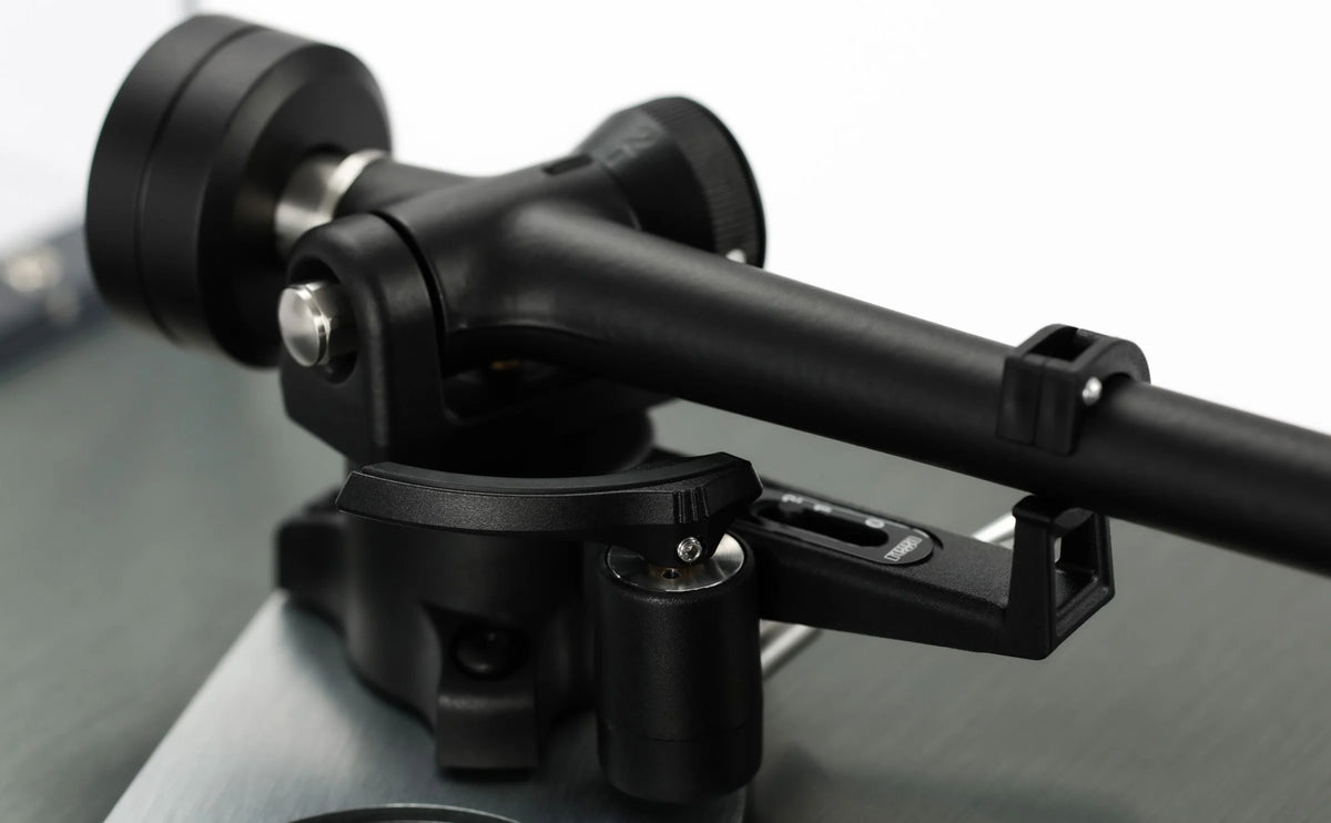 Close-up of Rega Planar 3 RS turntable with aluminum platter and Nd5 cartridge, showing detailed bias housing.