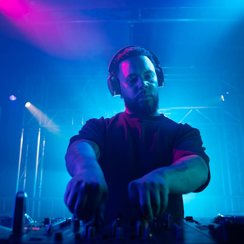 DJ performing with AlphaTheta HDJ-F9 headphones