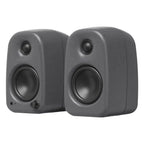 Kanto Audio UKI desktop speakers with sleek black finish and front speaker grille, designed for high-quality audio on a desk.