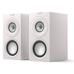 KEF Q Concerto Meta passive bookshelf speakers shown in a stylish home setup, highlighting their sleek design and compact size.